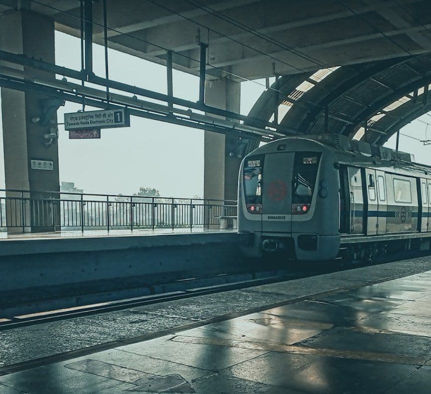Metro train arriving at a modern elevated station illustrating Ahmedabad Metro expansion
