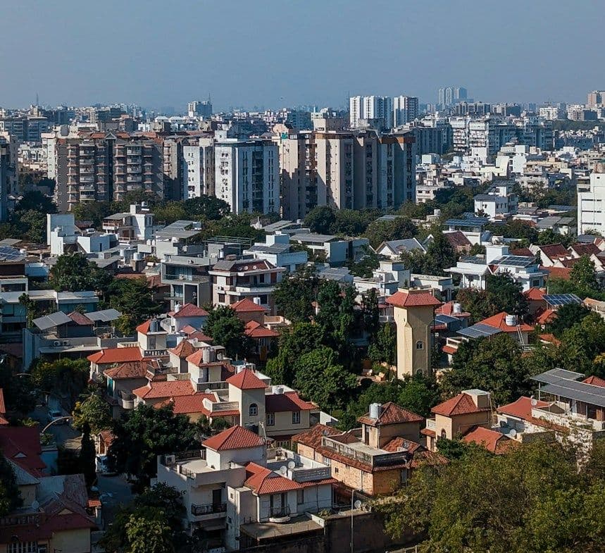 Ahmedabad cityscape with residential towers, bungalows and greenery in the western suburbs